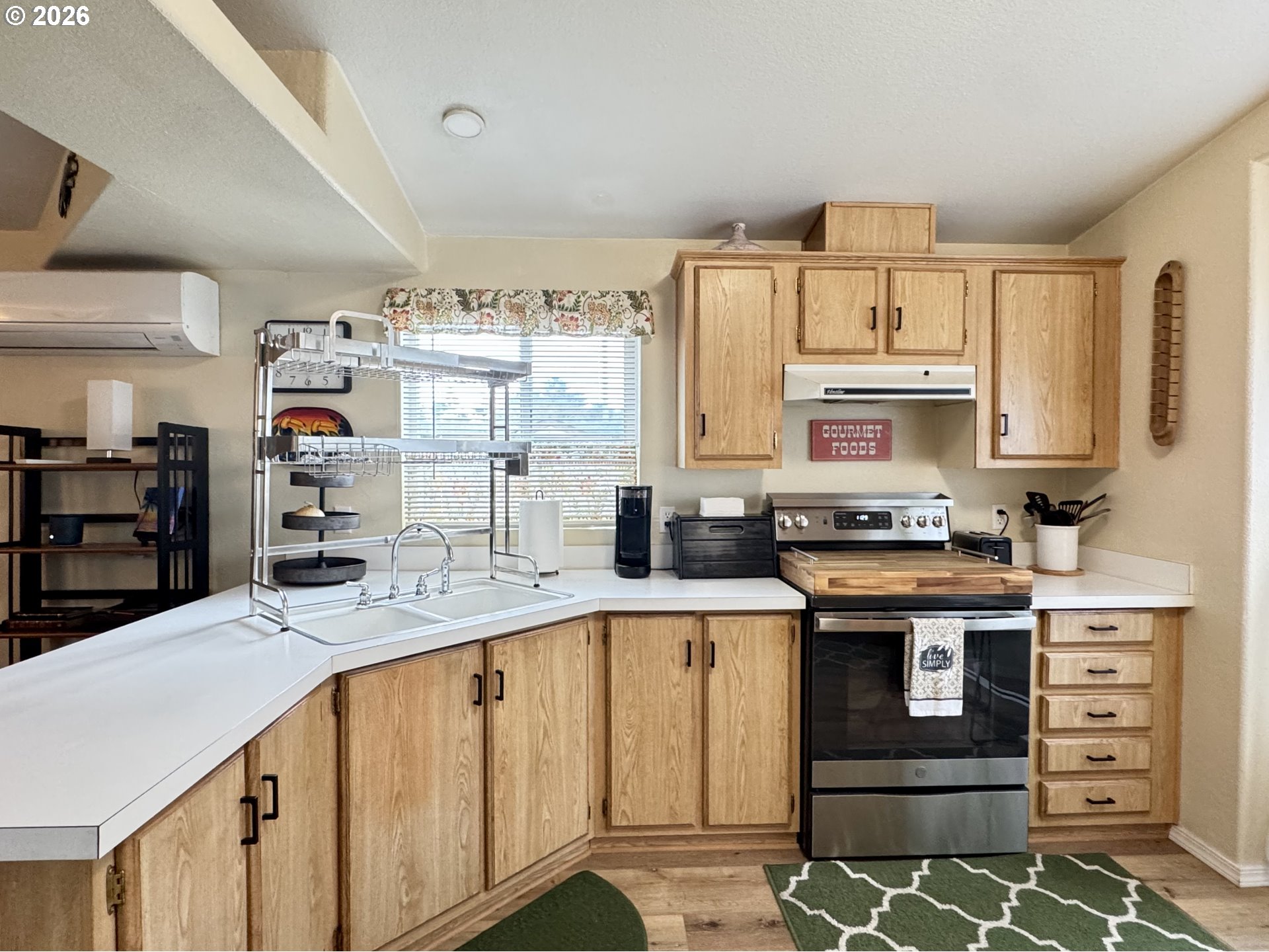 3760 Highway 101, Unit 1 Florence, OR 97439 - Photo 22 of 32 a kitchen with stainless steel appliances granite countertop a sink and cabinets