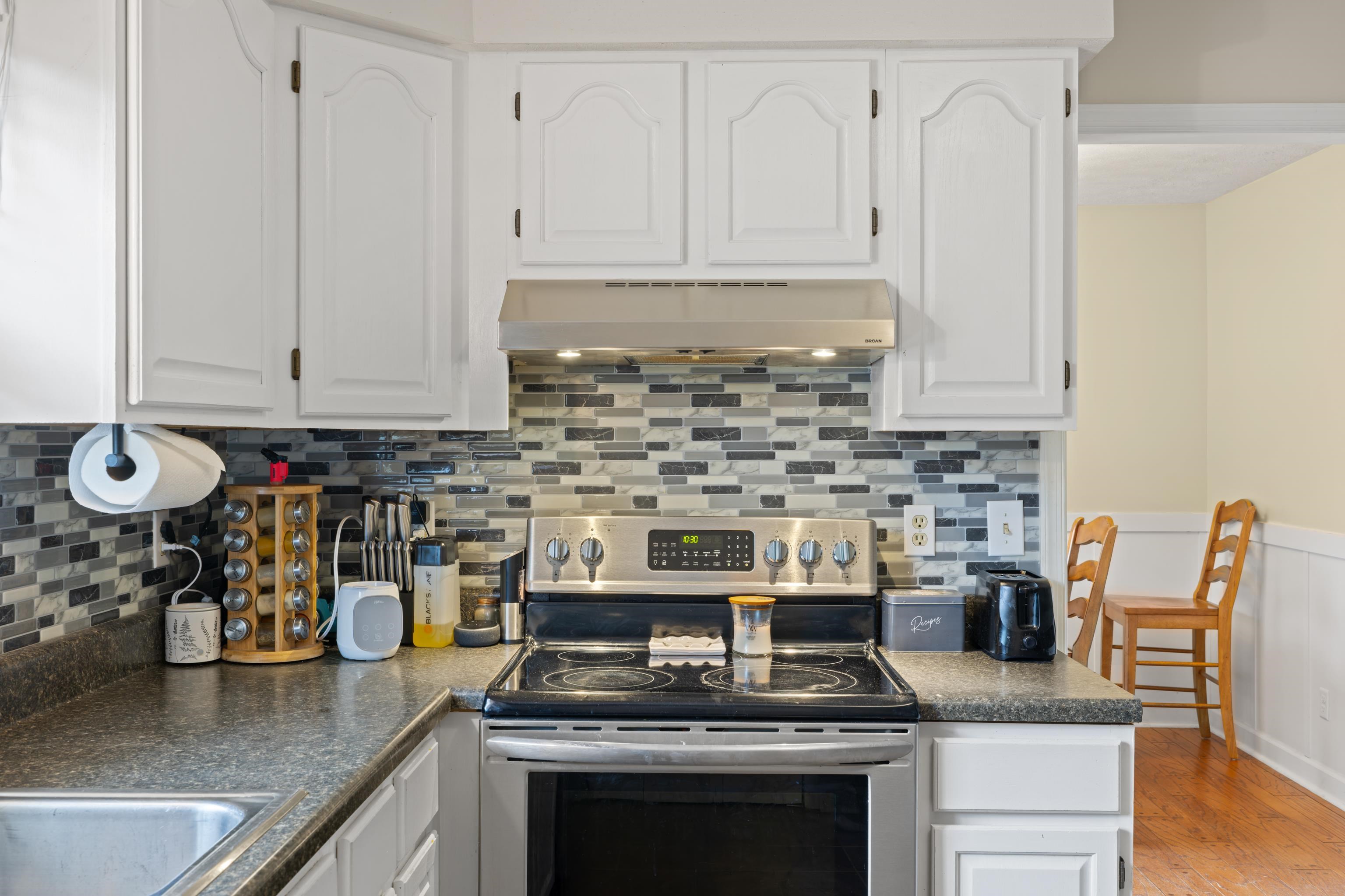 701 Horseshoe Circle Stuarts Draft, VA 24477 - Photo 16 of 70 a kitchen with granite countertop a stove sink and cabinets