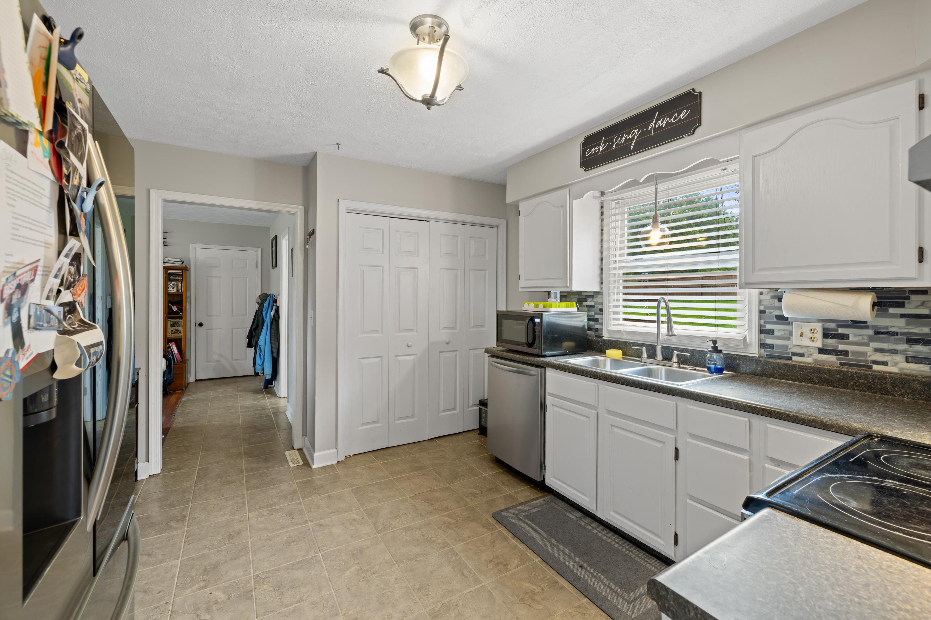 701 Horseshoe Circle Stuarts Draft, VA 24477 - Photo 17 of 70 a kitchen with a sink appliances and cabinets