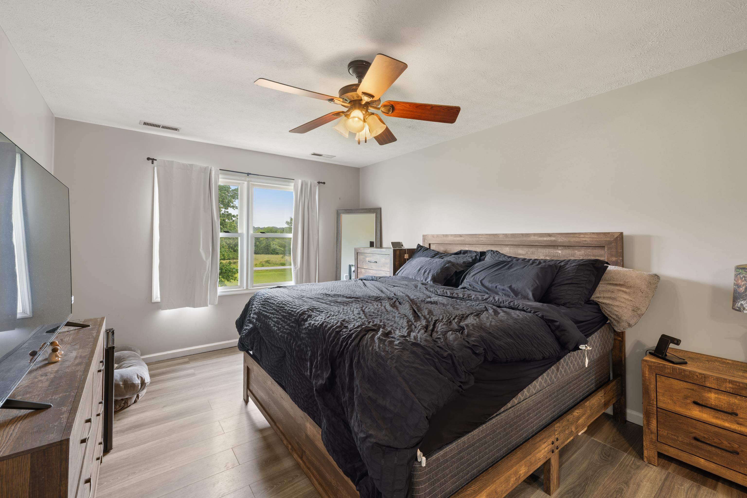 701 Horseshoe Circle Stuarts Draft, VA 24477 - Photo 23 of 70 a bed sitting in a bedroom next to a window