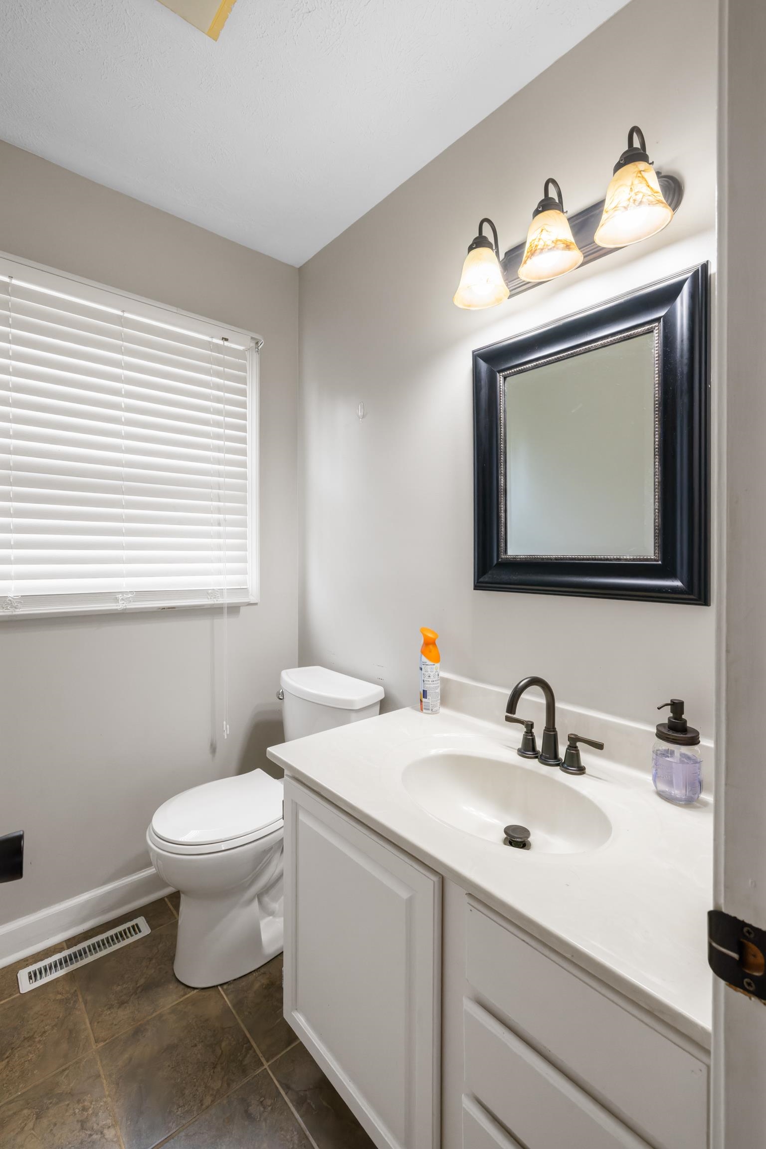 701 Horseshoe Circle Stuarts Draft, VA 24477 - Photo 40 of 70 a bathroom with a toilet sink and mirror