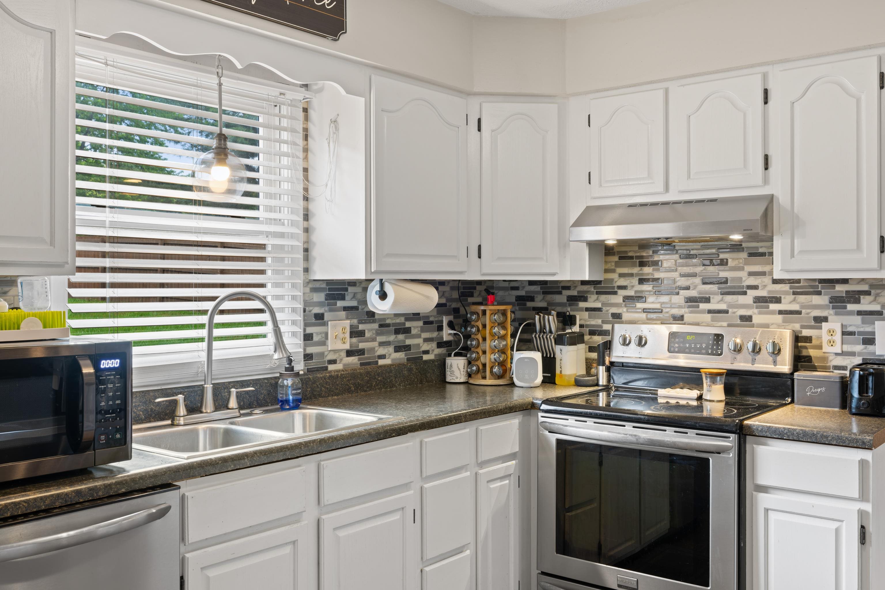 701 Horseshoe Circle Stuarts Draft, VA 24477 - Photo 10 of 70 a kitchen with stainless steel appliances granite countertop a sink a stove and a microwave