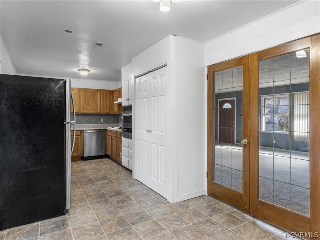 1314 Andover Road Henrico, VA 23229 - Photo 11 of 24 a kitchen with stainless steel appliances a refrigerator and a stove top oven
