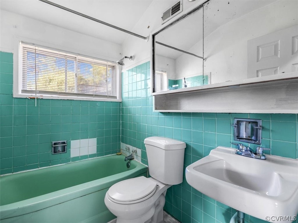 1314 Andover Road Henrico, VA 23229 - Photo 22 of 24 a white toilet sitting next to a bathroom sink and tub
