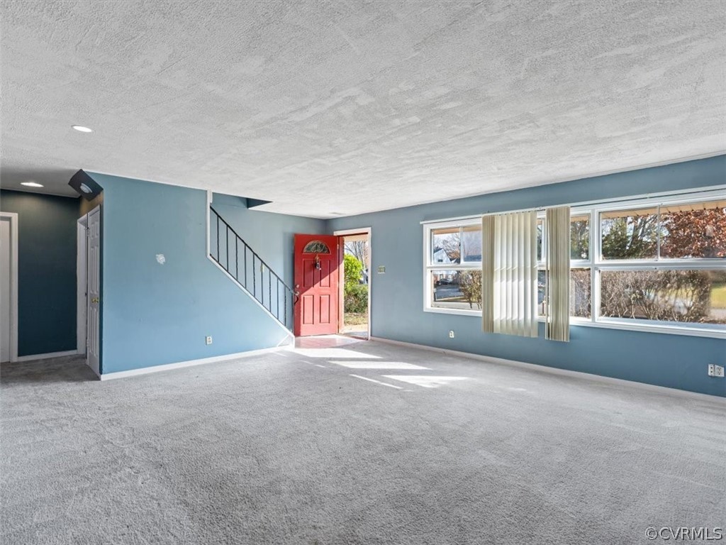 1314 Andover Road Henrico, VA 23229 - Photo 5 of 24 a view of an empty room with a fireplace and a large window