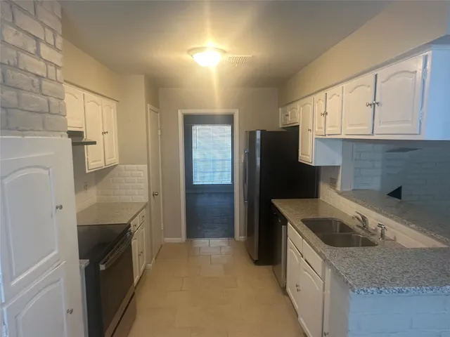 a kitchen with a sink stove and refrigerator