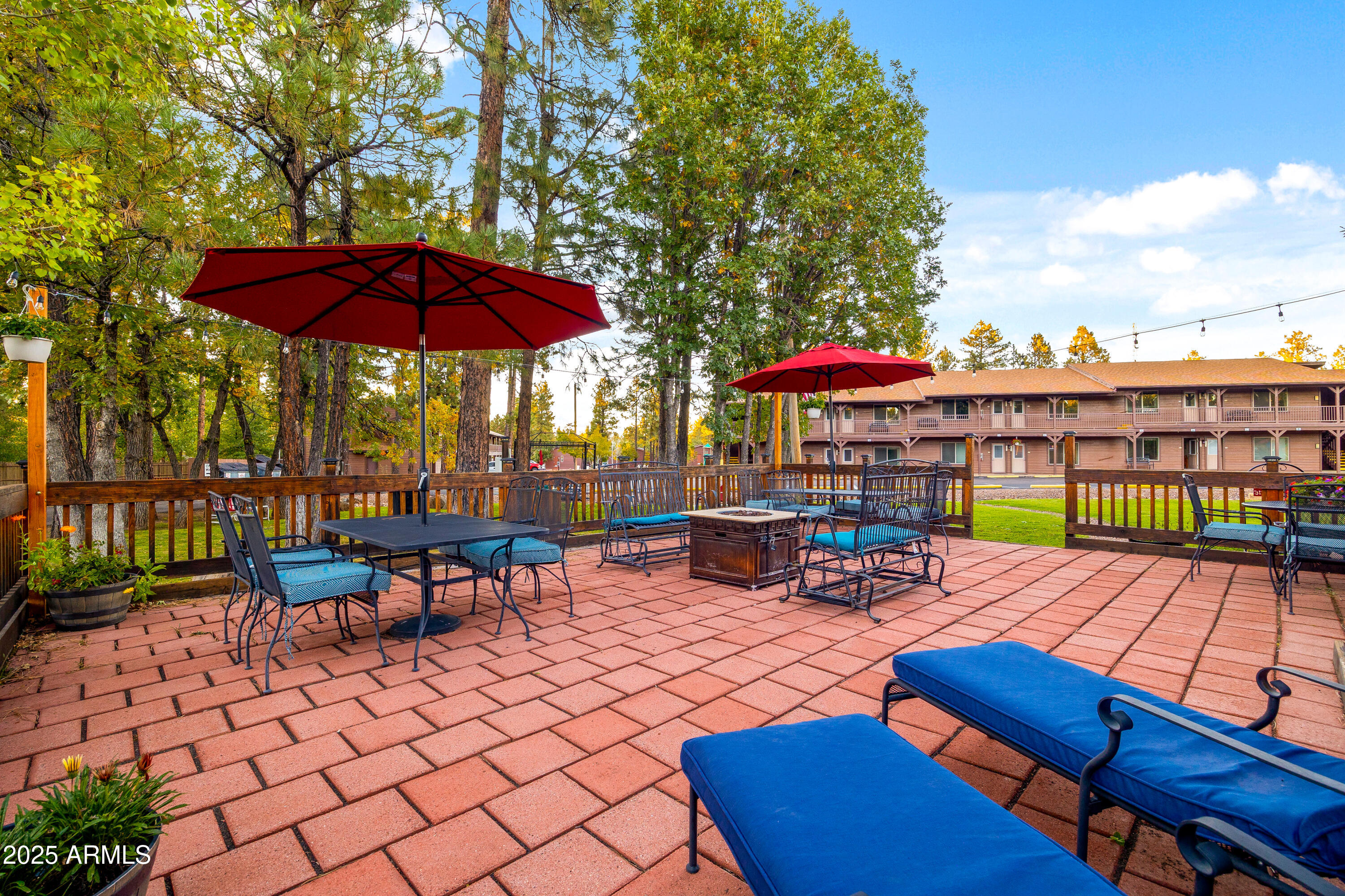 5829 East Buck Springs Road, Unit 200 Pinetop, AZ 85935 - Photo 17 of 18 a view of a patio with a table and chairs under an umbrella