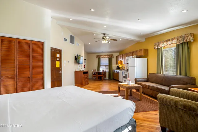 a bedroom with furniture and a large window