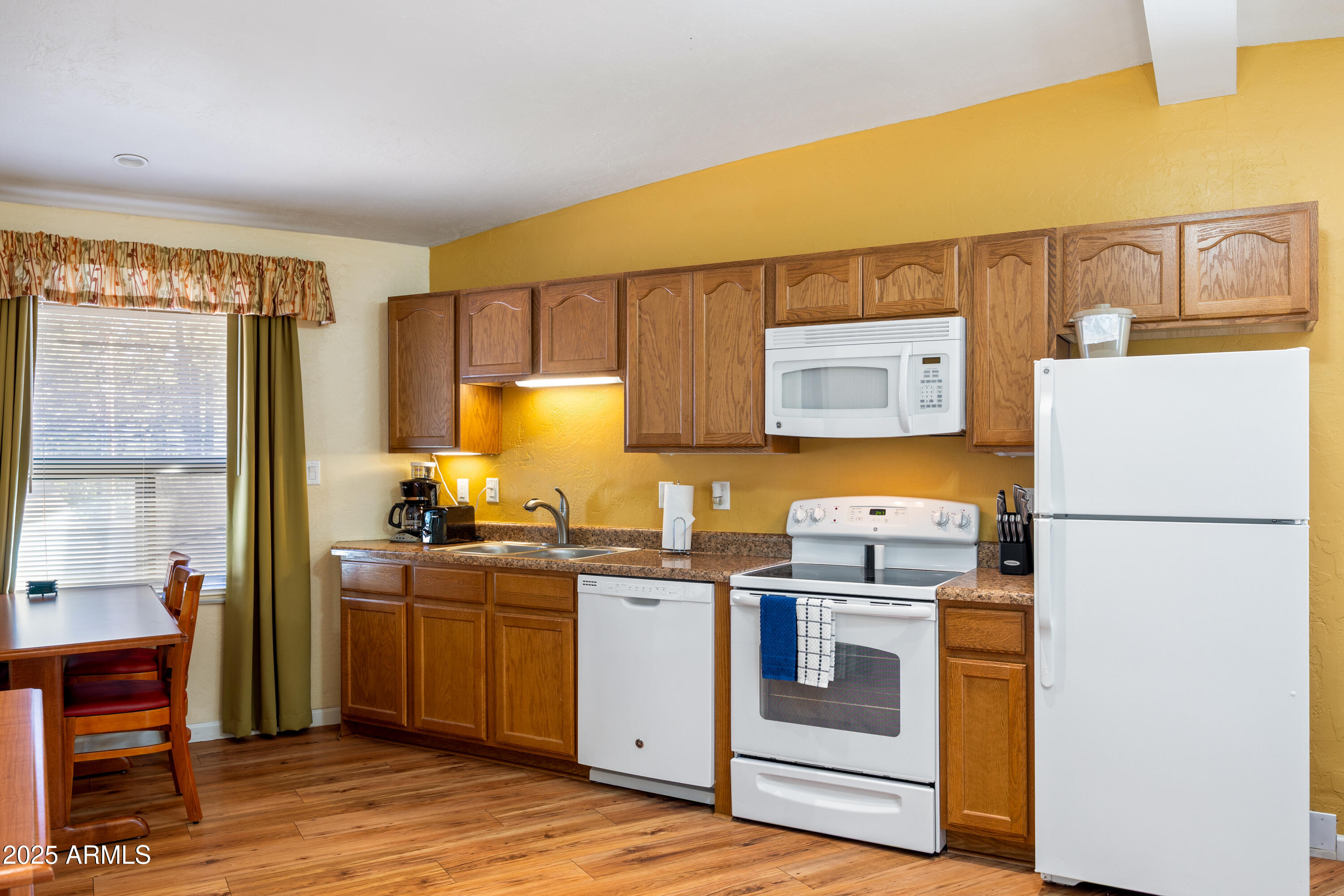 5829 East Buck Springs Road, Unit 200 Pinetop, AZ 85935 - Photo 4 of 18 a kitchen with a sink a stove and refrigerator