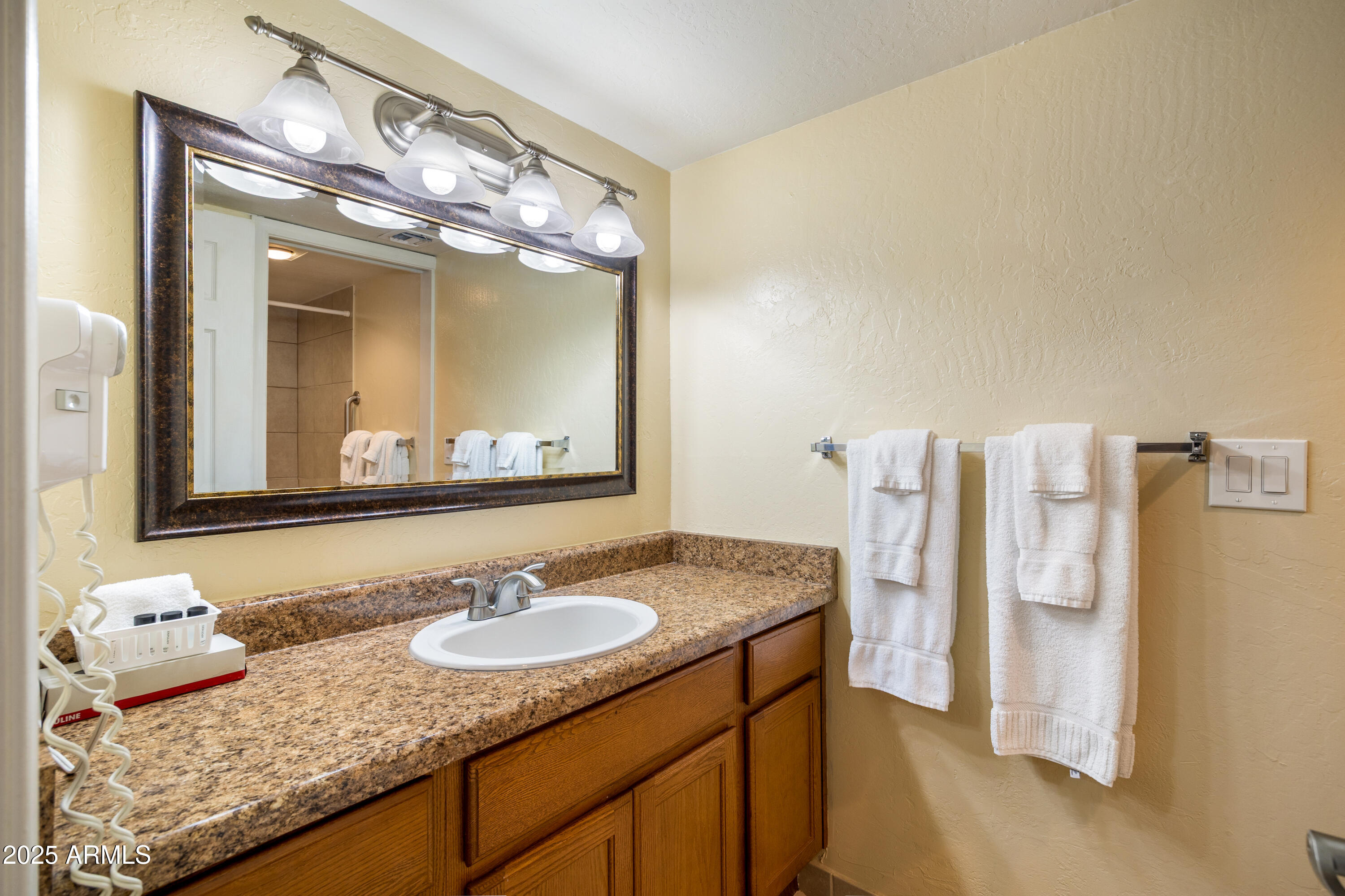 5829 East Buck Springs Road, Unit 200 Pinetop, AZ 85935 - Photo 6 of 18 a bathroom with double vanity and a mirror
