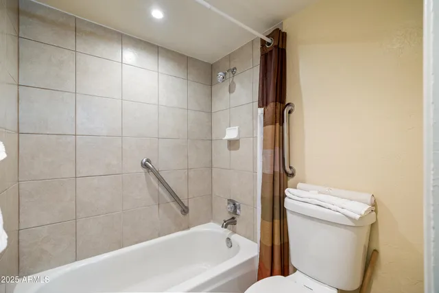 a bathroom with a toilet and a bathtub