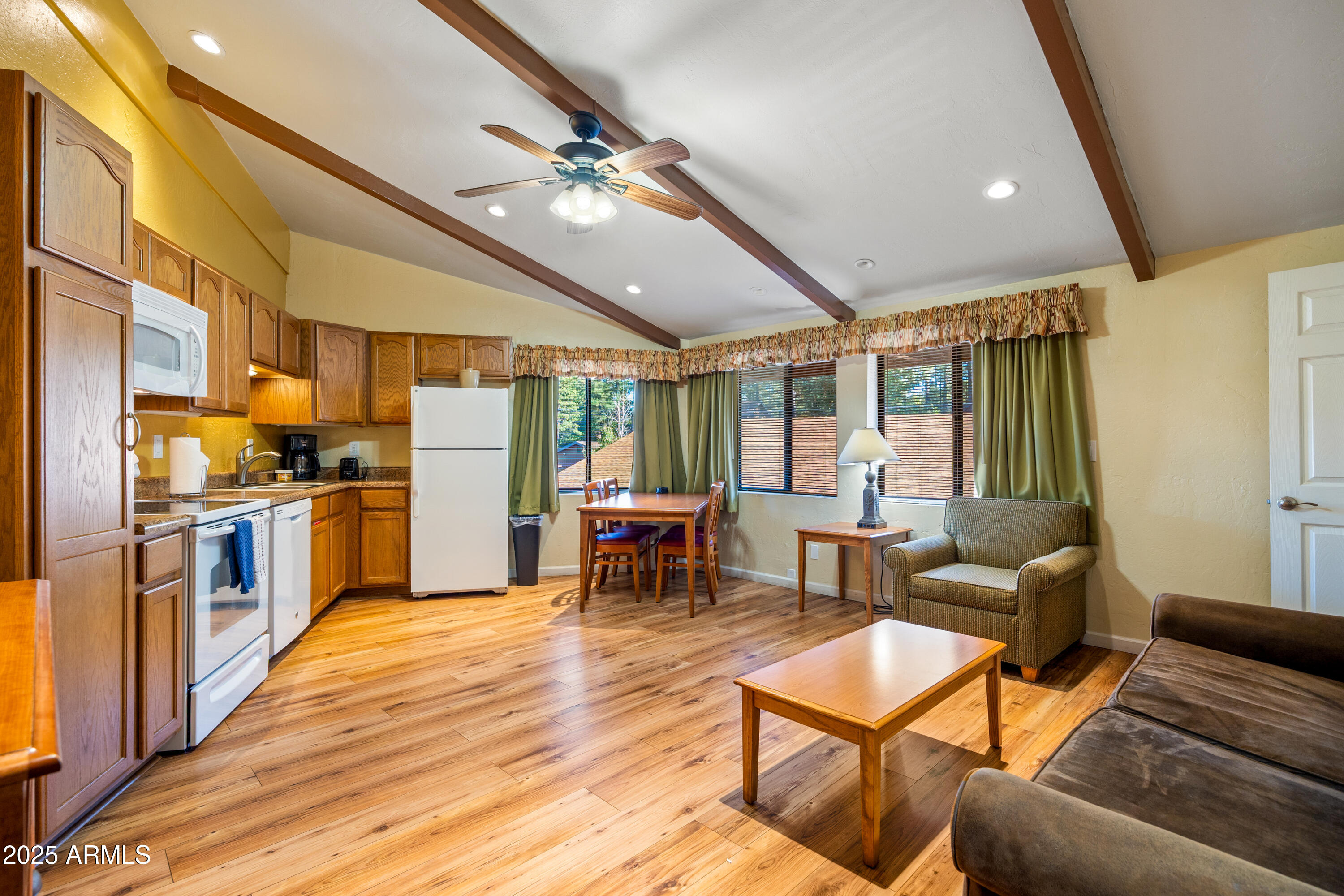 5829 East Buck Springs Road, Unit 200 Pinetop, AZ 85935 - Photo 8 of 18 a living room with furniture and kitchen view
