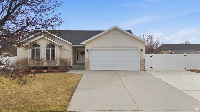 2127 Silver Tree Circle Riverton, UT 84065 - Photo 1 of 1 Ranch-style home featuring stucco siding, concrete driveway, an attached garage, a shingled roof, and a gate