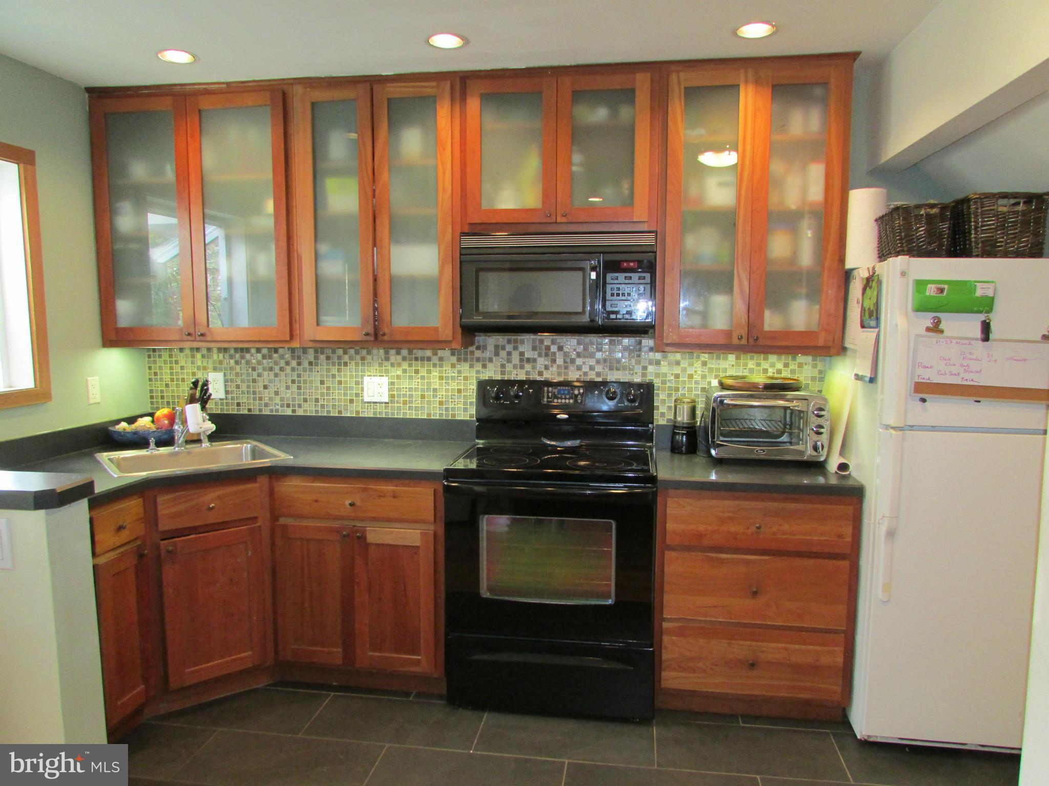 54 Ridge Road, Unit L Greenbelt, MD 20770 - Photo 3 of 18 a kitchen with stainless steel appliances granite countertop a stove a sink and a microwave