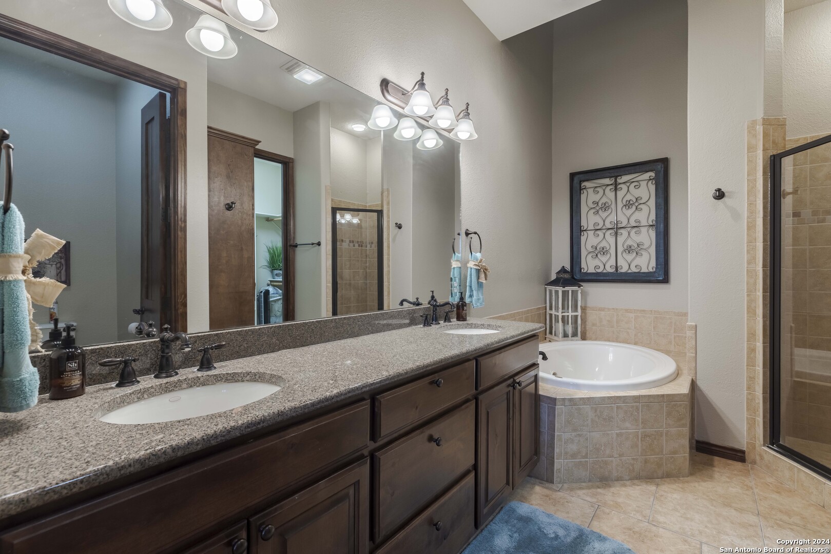 3801-15 Club House Road, Unit 15 Kerrville, TX 78028 - Photo 11 of 26 a bathroom with a granite countertop sink a toilet a mirror and bathtub