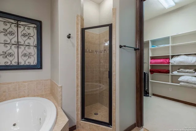 a bathroom with a tub and shower