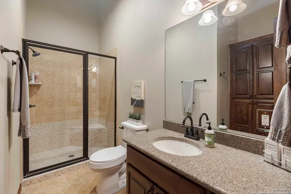 a bathroom with a glass shower door