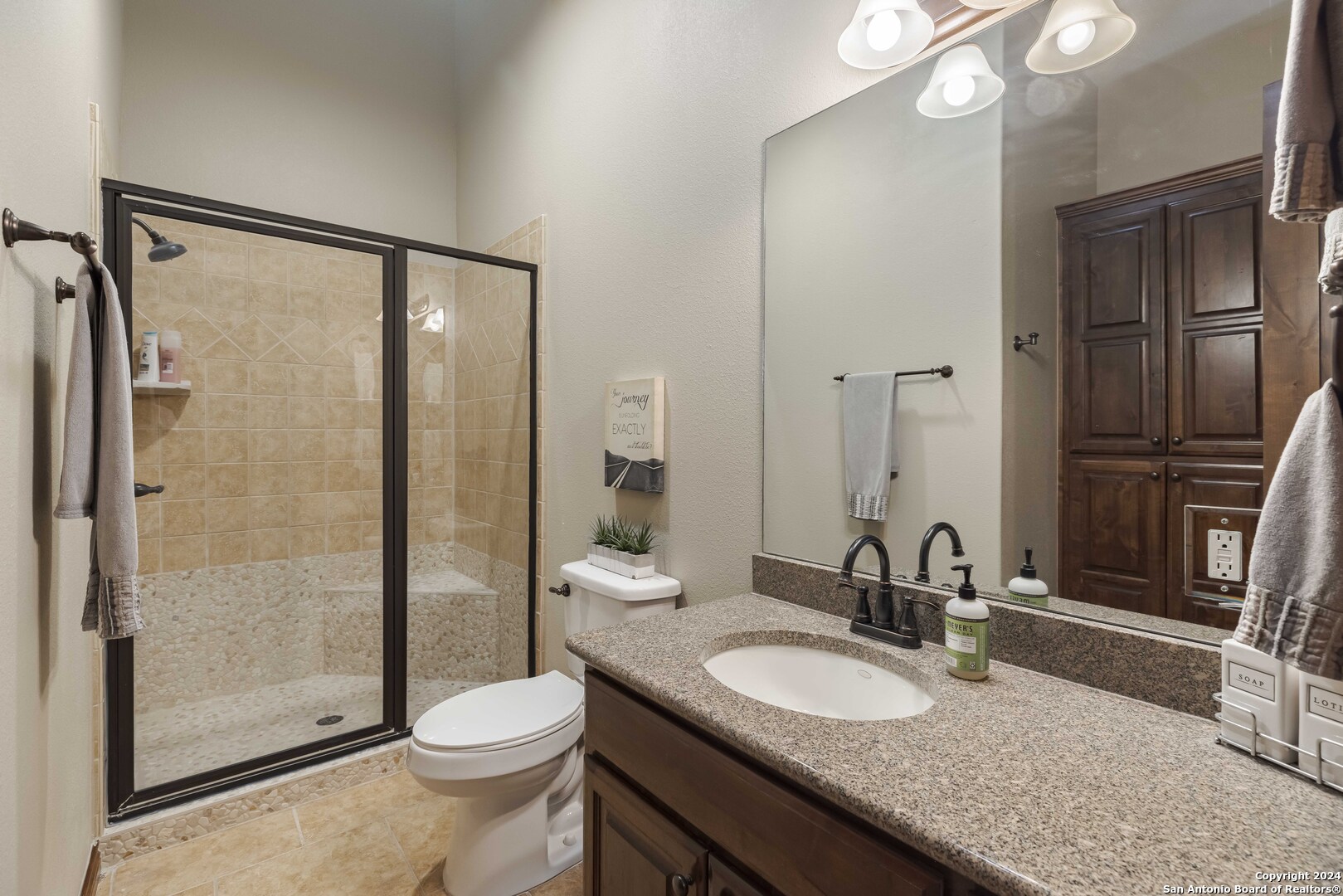 3801-15 Club House Road, Unit 15 Kerrville, TX 78028 - Photo 17 of 26 a bathroom with a granite countertop sink toilet and shower