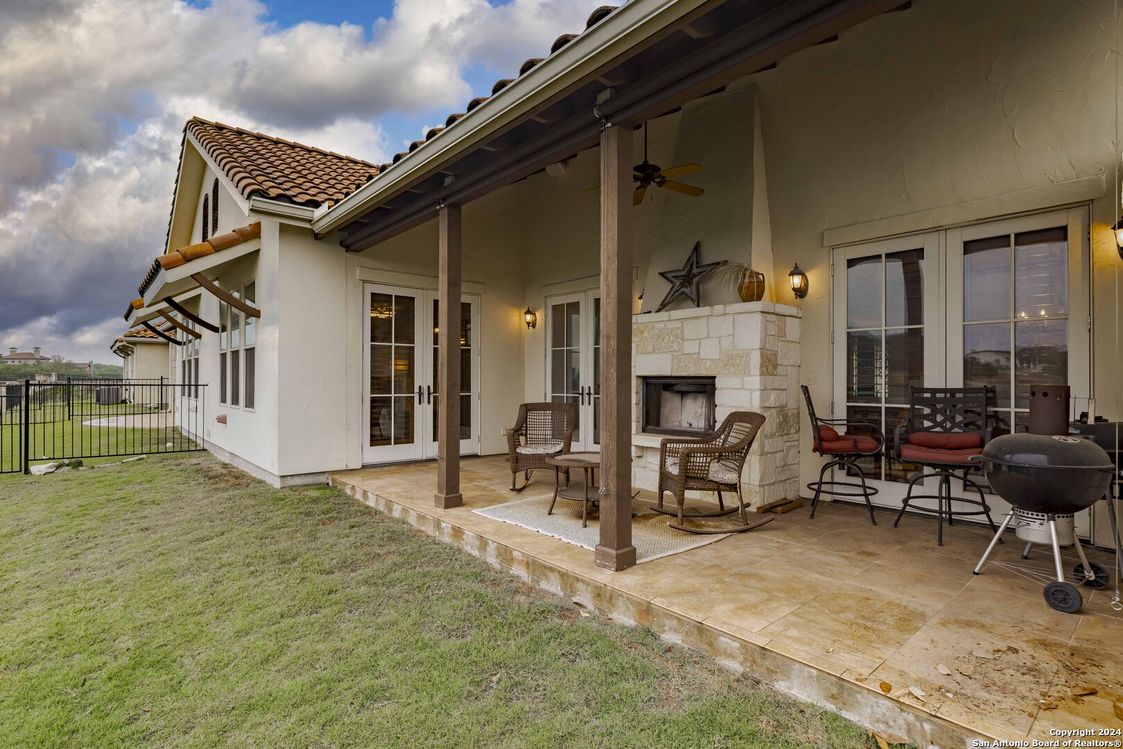 3801-15 Club House Road, Unit 15 Kerrville, TX 78028 - Photo 21 of 26 a building outdoor space with patio furniture and a fireplace