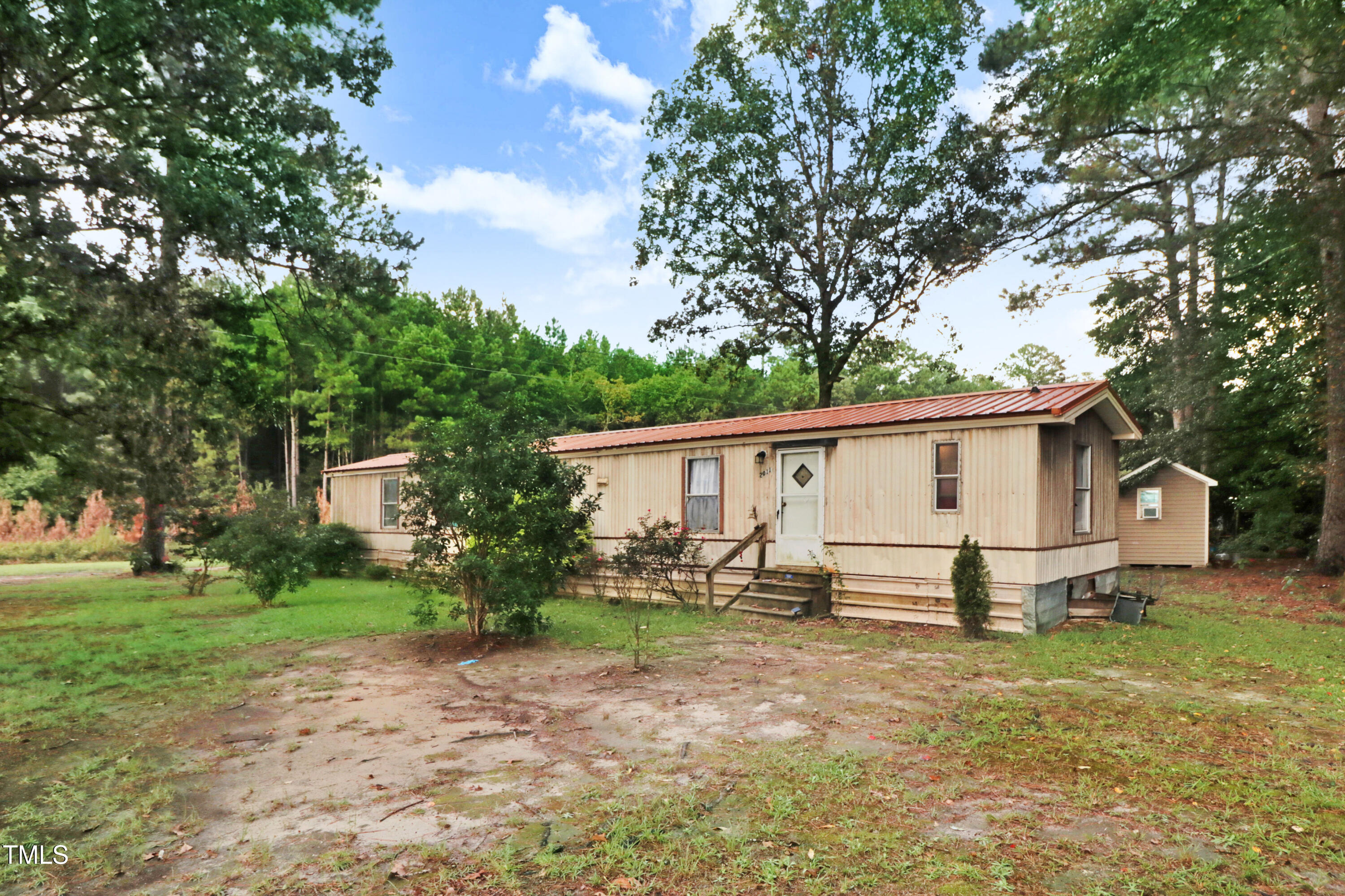 2037 Old Rock Quarry Road Princeton, NC 27569 - Photo 2 of 25 a view of a backyard with a large tree