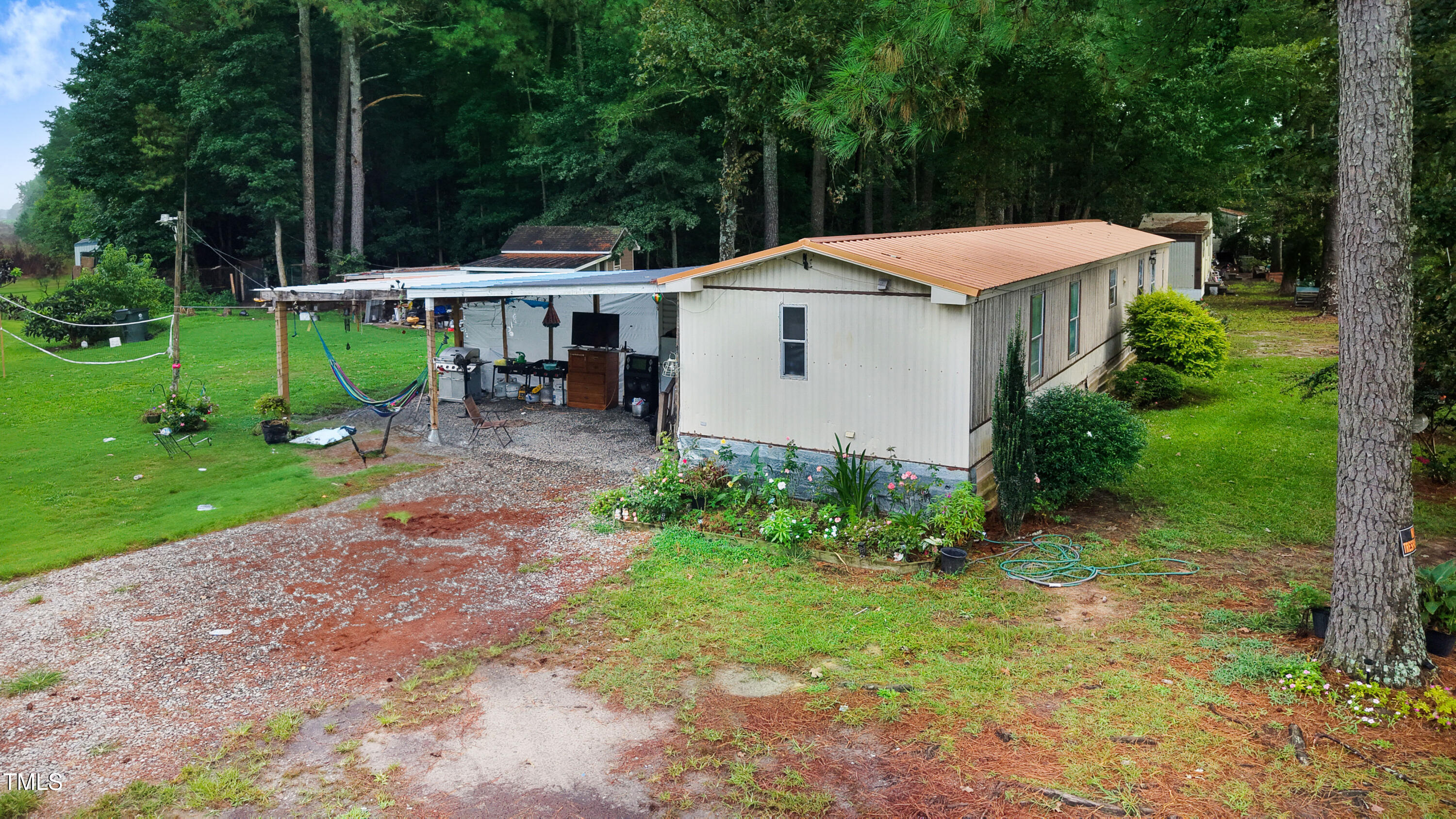 2037 Old Rock Quarry Road Princeton, NC 27569 - Photo 24 of 25 a backyard of a house with plants and outdoor seating