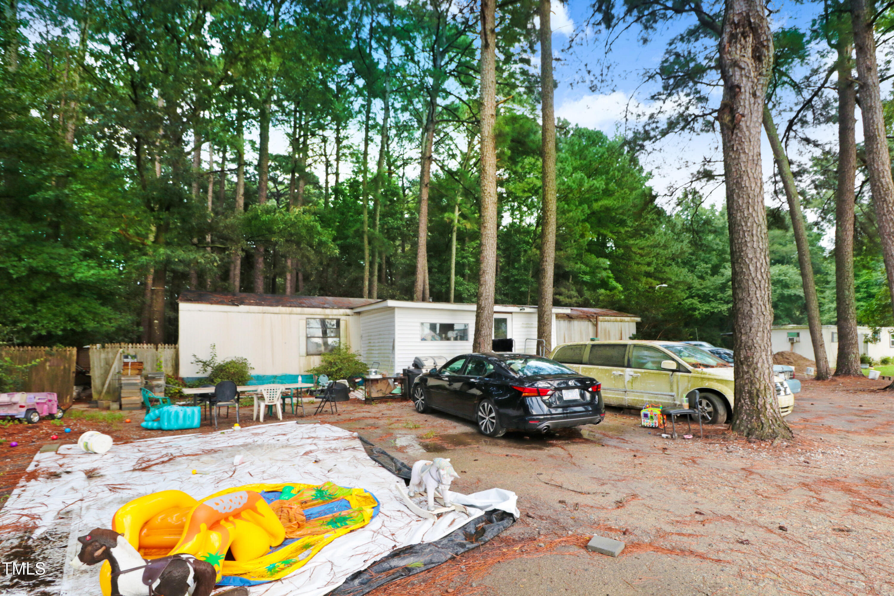 2037 Old Rock Quarry Road Princeton, NC 27569 - Photo 7 of 25 a view of a patio with a table chairs and a swimming pool
