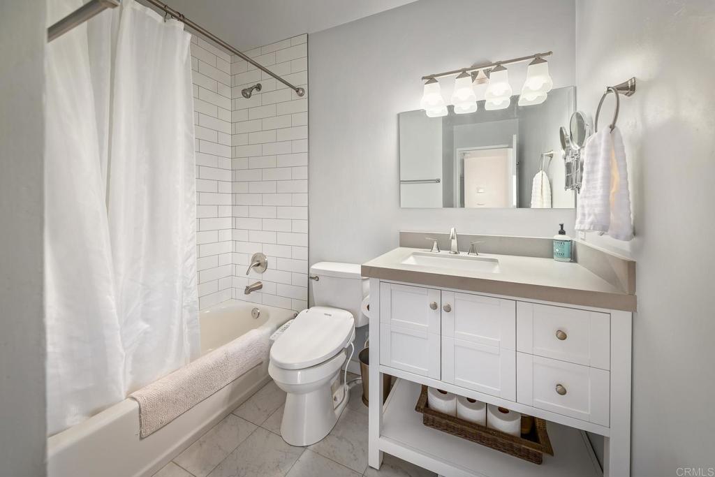 1467 Ronda Place Escondido, CA 92027 - Photo 11 of 26 a spacious bathroom with a toilet a sink and a mirror