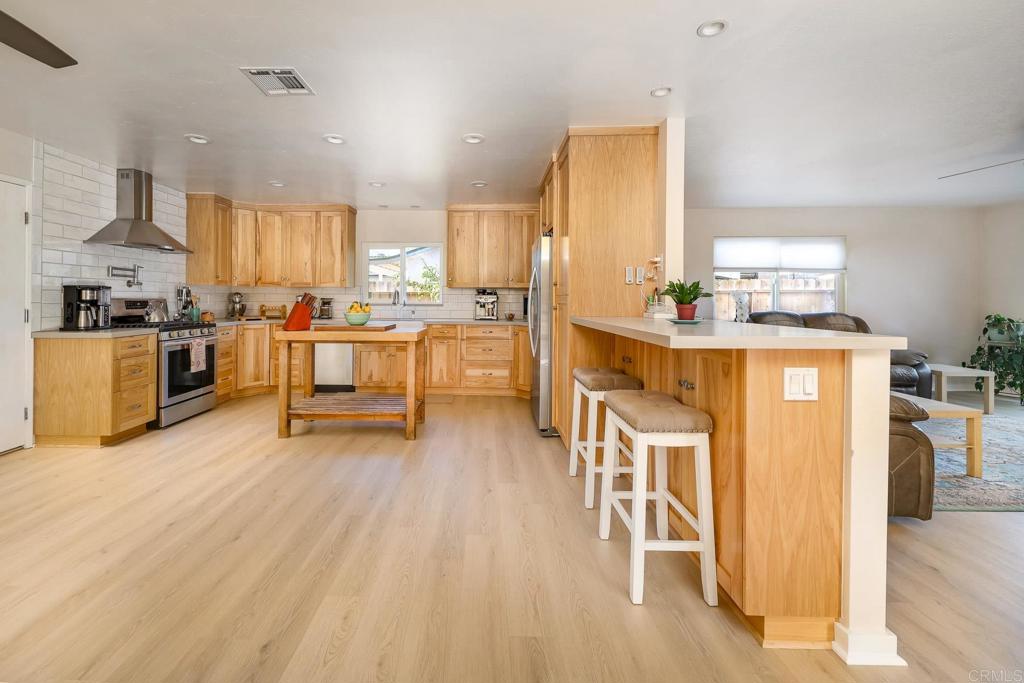 1467 Ronda Place Escondido, CA 92027 - Photo 6 of 26 a kitchen with stainless steel appliances a stove a sink dishwasher and a refrigerator