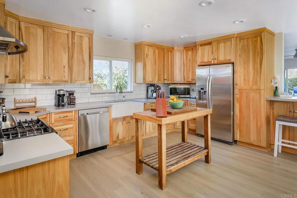 1467 Ronda Place Escondido, CA 92027 - Photo 7 of 26 a kitchen with a sink appliances and cabinets