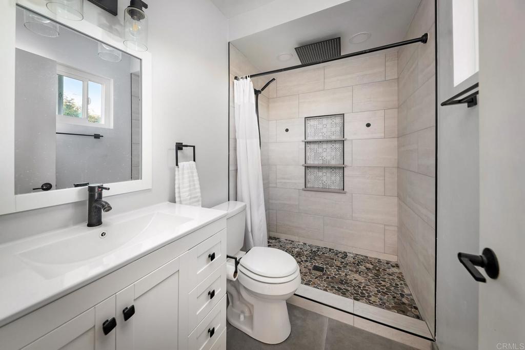 1467 Ronda Place Escondido, CA 92027 - Photo 9 of 26 a bathroom with a sink a toilet and shower