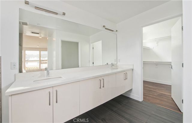 a bathroom with a sink double vanity and a mirror