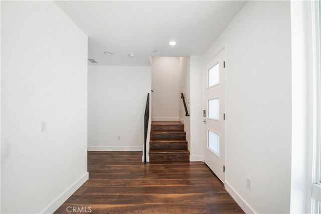 a view of entryway with stairs and wooden floor