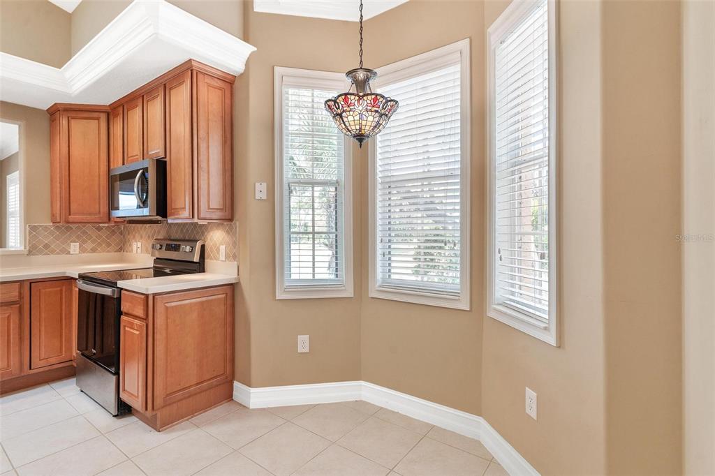 14 Camino Real, Unit 14 Howey-in-the-Hills, FL 34737 - Photo 13 of 62 a kitchen that has a stove and a window