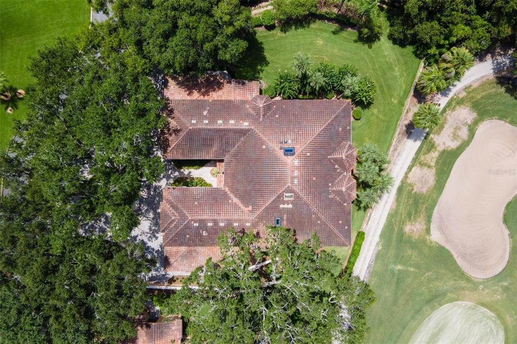 14 Camino Real, Unit 14 Howey-in-the-Hills, FL 34737 - Photo 2 of 62 an aerial view of a swimming pool with outdoor space and trees all around