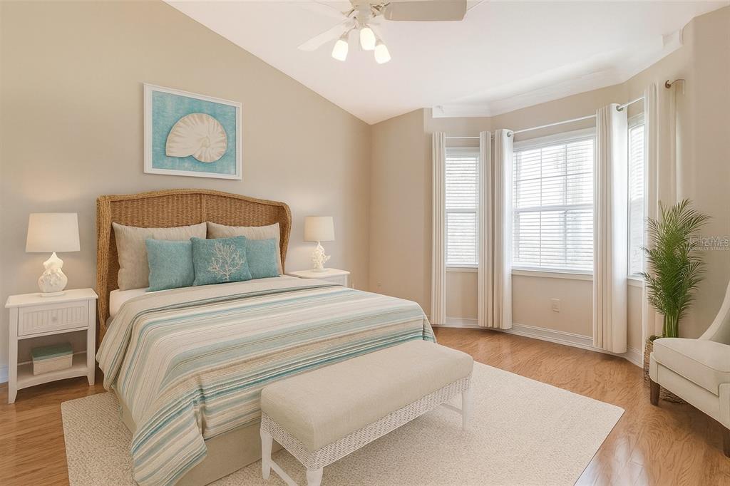 14 Camino Real, Unit 14 Howey-in-the-Hills, FL 34737 - Photo 21 of 62 a bedroom with a large bed and a window