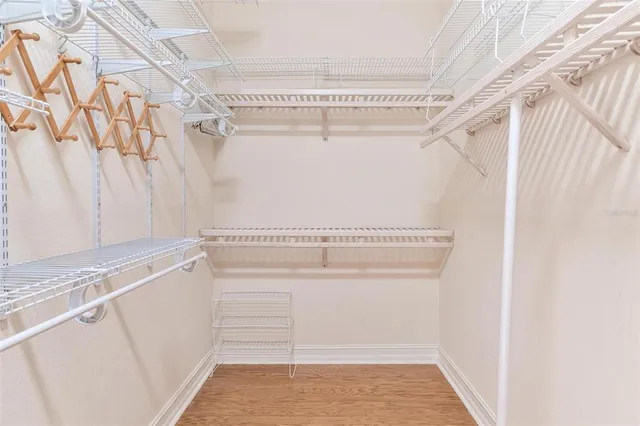 a bathroom with a tub a sink and mirror