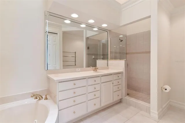 a view of an empty room with wooden floor and a bathroom