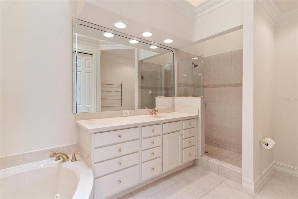14 Camino Real, Unit 14 Howey-in-the-Hills, FL 34737 - Photo 24 of 62 a bathroom with a double vanity sink mirror double and shower