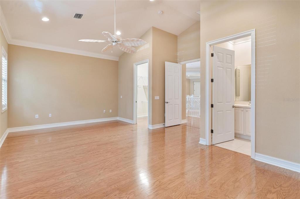 14 Camino Real, Unit 14 Howey-in-the-Hills, FL 34737 - Photo 28 of 62 a view of an empty room with wooden floor and a bathroom