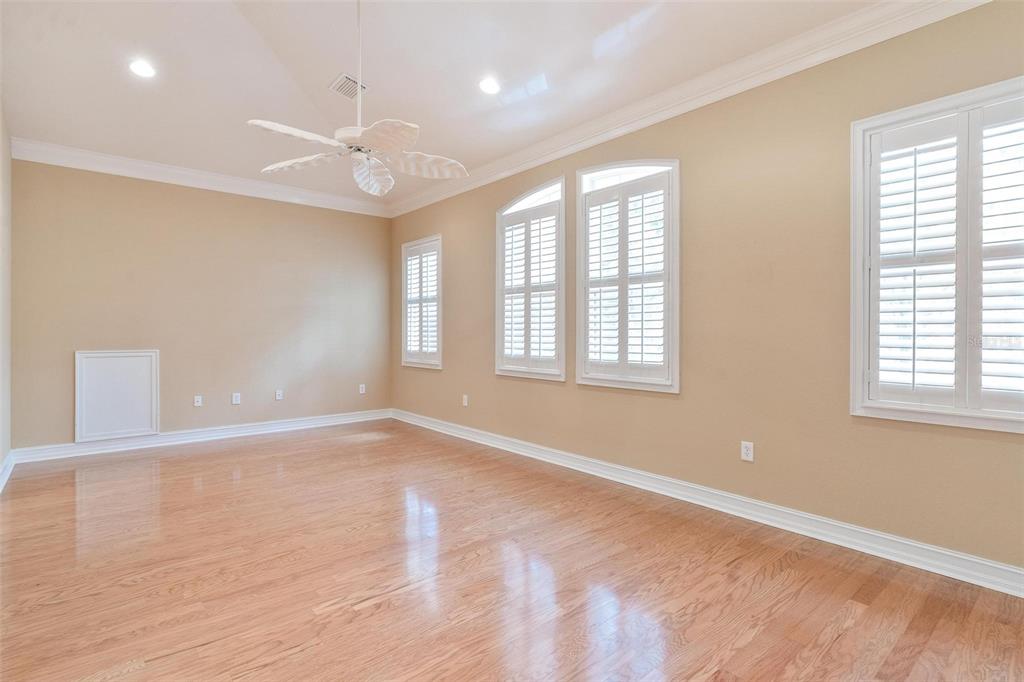 14 Camino Real, Unit 14 Howey-in-the-Hills, FL 34737 - Photo 29 of 62 a view of an empty room with wooden floor and a window
