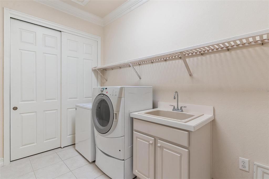 14 Camino Real, Unit 14 Howey-in-the-Hills, FL 34737 - Photo 37 of 62 a utility room with sink dryer and washer