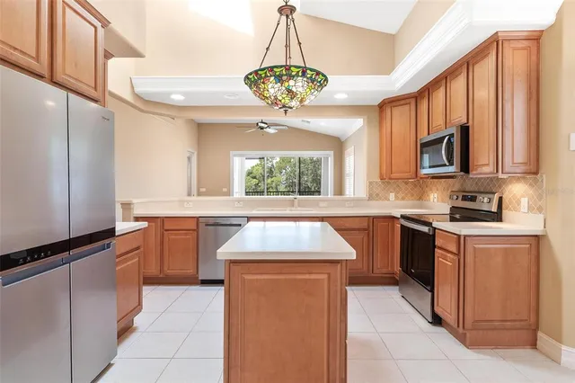 a kitchen with stainless steel appliances granite countertop a stove and a sink