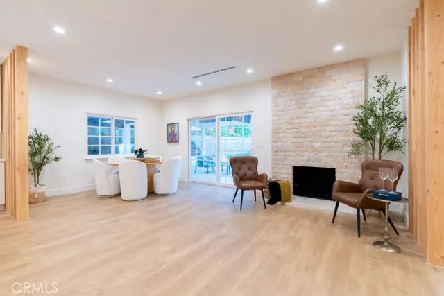a living room with furniture a fireplace and a potted plant