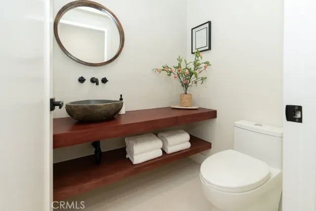 a bathroom with a toilet a sink and a mirror