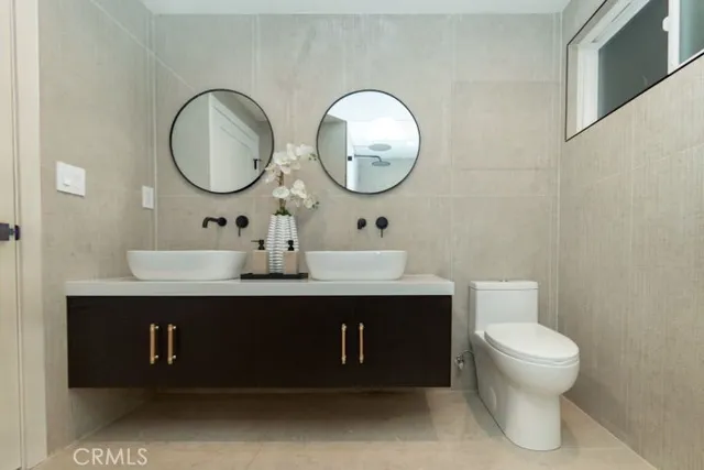 a bathroom with a toilet a sink and a mirror