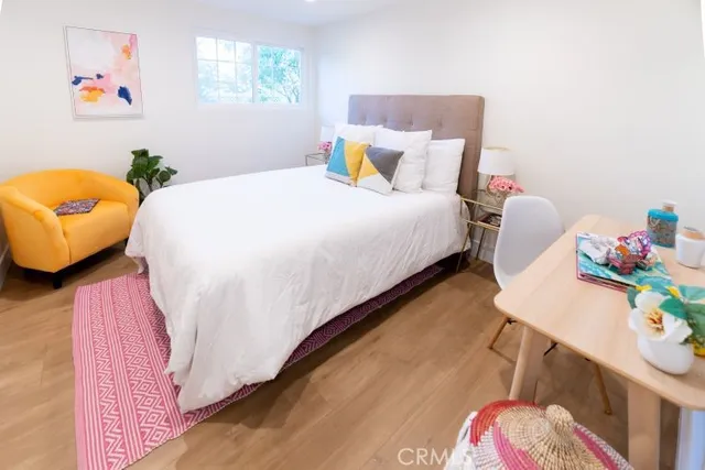 a bedroom with a bed and wooden floor