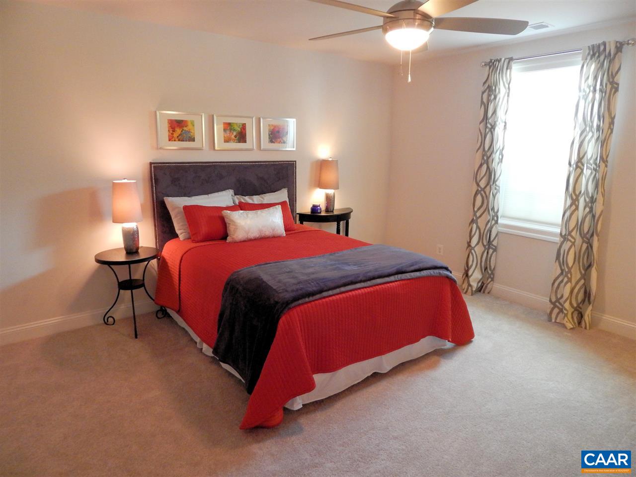 2055 Avinity Loop Charlottesville, VA 22902 - Photo 4 of 28 a bedroom with a bed and a chandelier