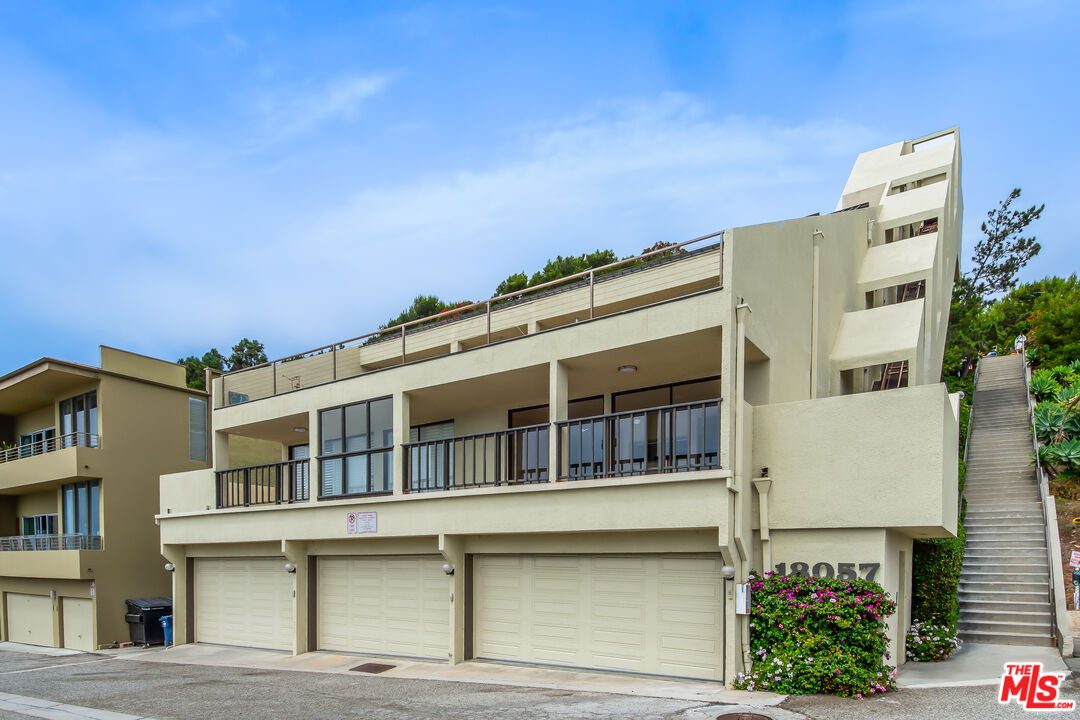 18057 Coastline Drive, Unit 5 Malibu, CA 90265 - Photo 3 of 20 a large building with a lot of windows