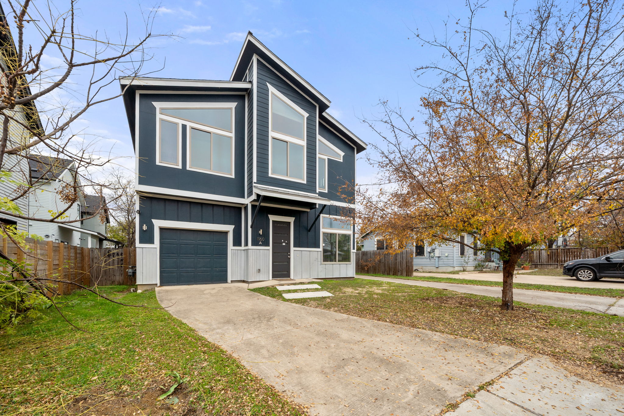 1160 Nickols Avenue, Unit A Austin, TX 78721 - Photo 1 of 40 Contemporary house featuring board and batten siding, a garage, and concrete driveway