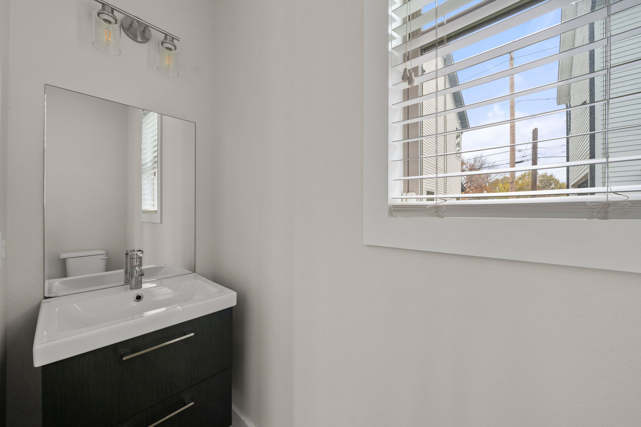 1160 Nickols Avenue, Unit A Austin, TX 78721 - Photo 9 of 40 Half bathroom featuring vanity